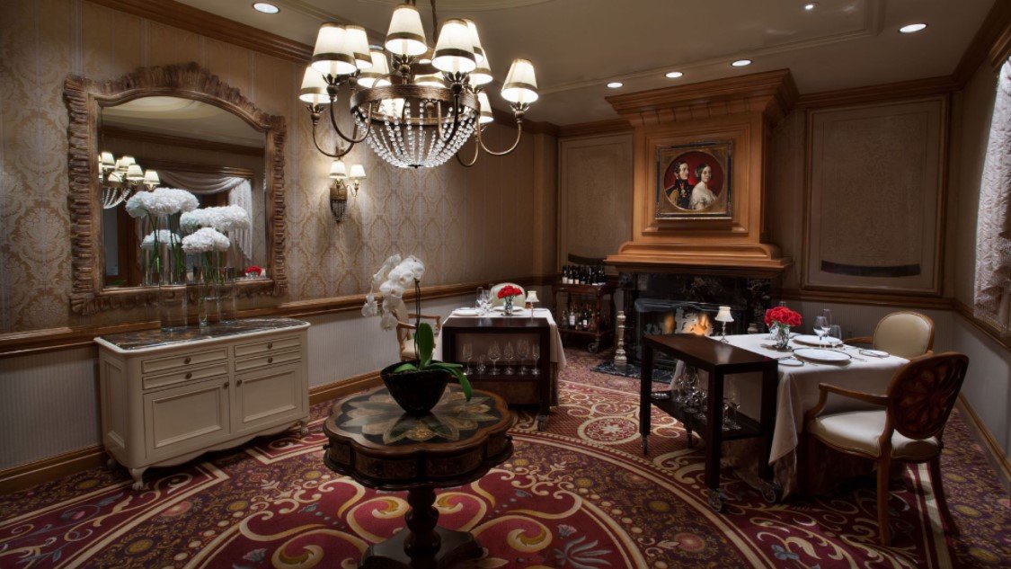 private room with victorian decor and tables with red roses